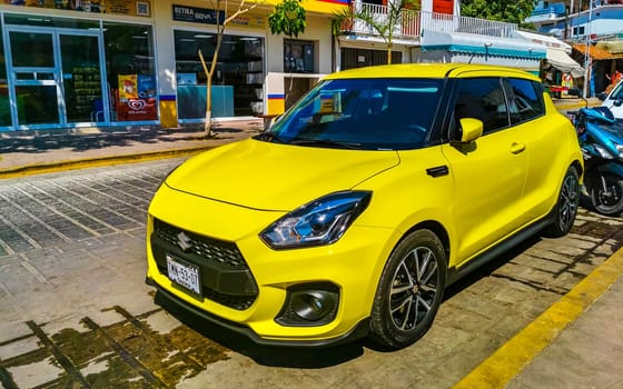 Yellow car vehicle transportation modern in the city town in Zicatela Puerto Escondido Oaxaca Mexico.