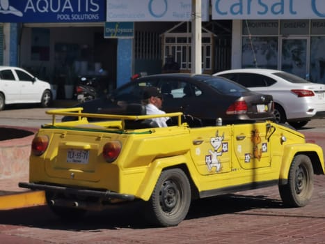 Yellow car vehicle transportation modern retro in the city town in Zicatela Puerto Escondido Oaxaca Mexico.