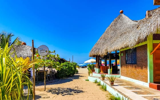 Restaurant restaurants bar bars shops hotels palms palm trees and promenades on the beach in Zicatela Puerto Escondido Oaxaca Mexico.