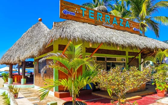 Restaurant restaurants bar bars shops hotels palms palm trees and promenades on the beach in Zicatela Puerto Escondido Oaxaca Mexico.