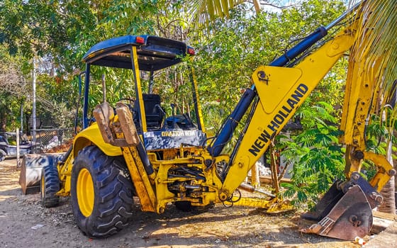 Yellow excavator with shovel in Zicatela Puerto Escondido Oaxaca Mexico.