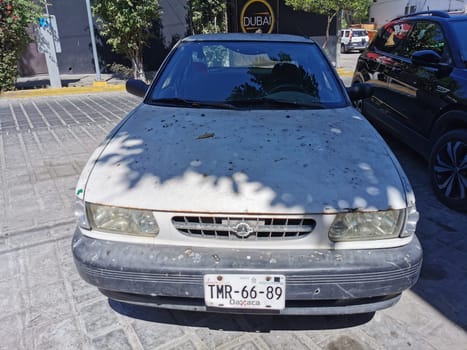 White silver gray grey car vehicle transportation in the city town in Zicatela Puerto Escondido Oaxaca Mexico.