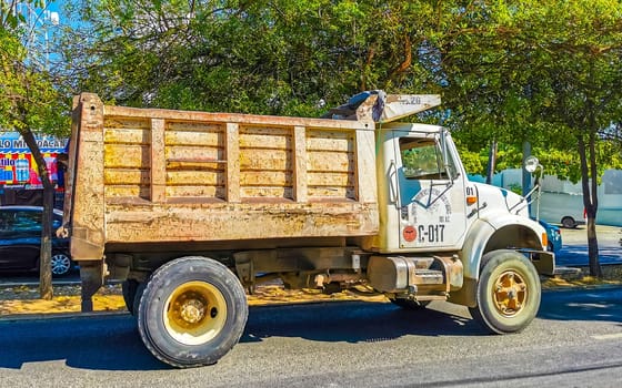 Mexican tipper dumper dump trucks truck cargo transporter delivery cars car vehicles in Puerto Escondido Zicatela Oaxaca Mexico.