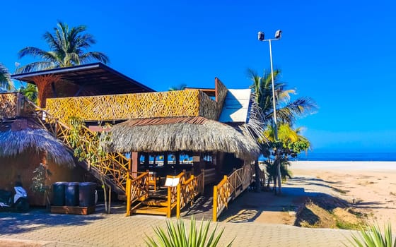 Restaurant restaurants bar bars shops hotels palms palm trees and promenades on the beach in Zicatela Puerto Escondido Oaxaca Mexico.