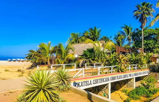 Restaurant restaurants bar bars shops hotels palms palm trees and promenades on the beach in Zicatela Puerto Escondido Oaxaca Mexico.