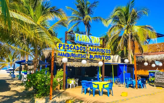 Restaurant restaurants bar bars shops hotels palms palm trees and promenades on the beach in Zicatela Puerto Escondido Oaxaca Mexico.