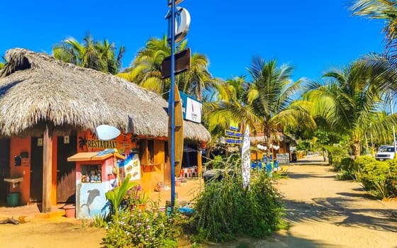 Restaurant restaurants bar bars shops hotels palms palm trees and promenades on the beach in Zicatela Puerto Escondido Oaxaca Mexico.