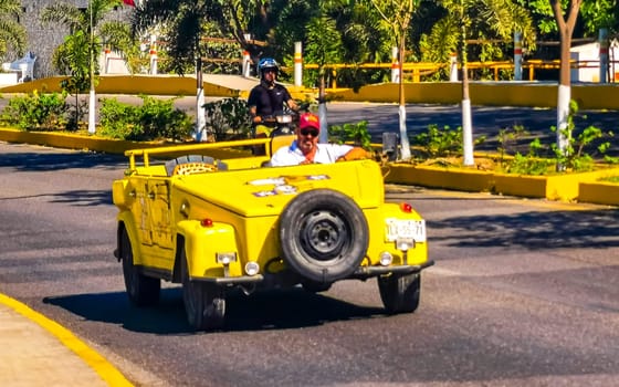 Yellow car vehicle transportation modern retro in the city town in Zicatela Puerto Escondido Oaxaca Mexico.