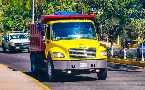 Mexican tipper dumper dump trucks truck cargo transporter delivery cars car vehicles in Puerto Escondido Zicatela Oaxaca Mexico.