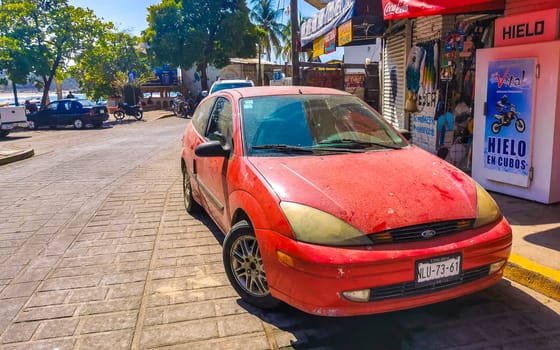 Red modern car vehicle transportation in the city town in Zicatela Puerto Escondido Oaxaca Mexico.