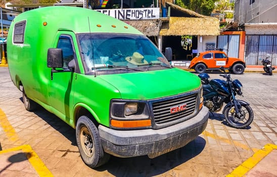 Green vintage retro classic car vehicle transportation in the city town in Zicatela Puerto Escondido Oaxaca Mexico.