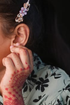 child having ear pain touching his painful ear