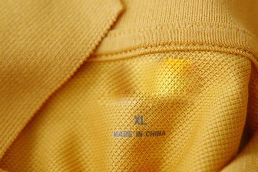 clothing label made in china on a yellow color shirt,