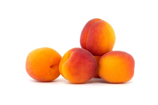 Collection of fresh ripe whole bright yellowish orange apricots isolated on a white background