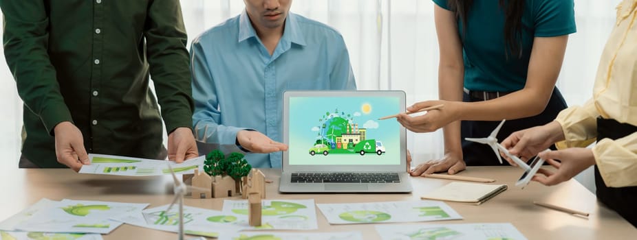 Green city and waste management illustrate displayed on laptop. Business team presenting green design to customer. ESG environment social governance and Eco conservative concept. Closeup. Delineation.