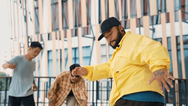 Hip hop team dance break dance while multicultural friend surrounded and clapping hands to cheer or encourage his friend to dance. Active and energetic street dance. Outdoor sport 2024. Endeavor.