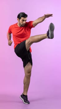 Full body length gaiety shot athletic and sporty young man with fitness in cardio exercise, kicking position posture on isolated background. Healthy active and body care lifestyle.