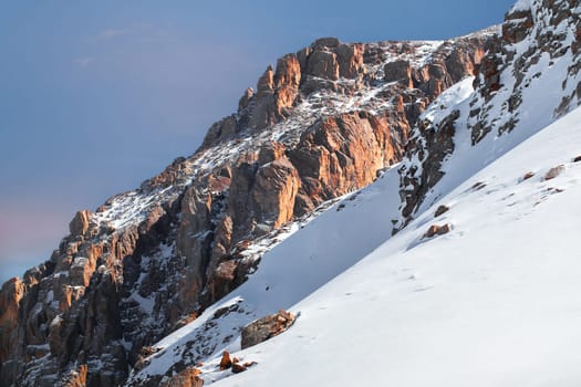 Beautiful amazing landscape of snowy mountains with picturesque red rock in central Asia in the Tian Shan mountains in Kazakhstan near Almaty.