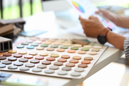 Cropped shot of interior designer working with palette choosing colors for house renovation.