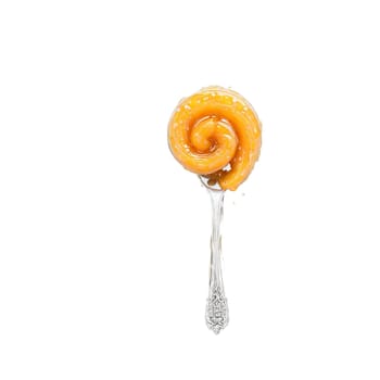 Apricot vanilla bean preserves swirl golden and speckled twirling off a spoon with apricot halves. Food isolated on transparent background.