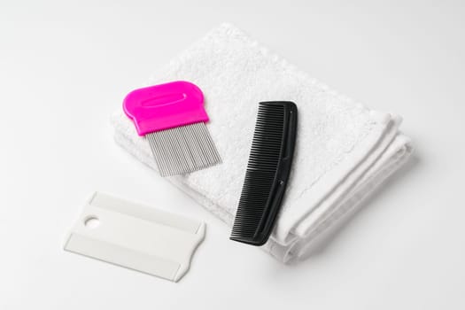 Anti lice combs and towel on white background close up