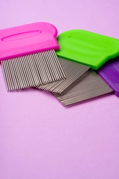 Three combs for removing lice and nits on lilac background close up