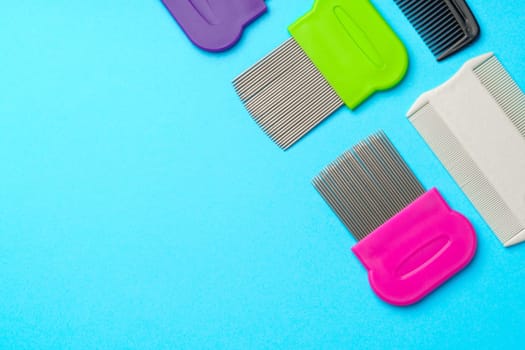 Comb for lice removing on blue background studio shot