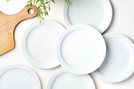 Set of white dinner plates on white background close up