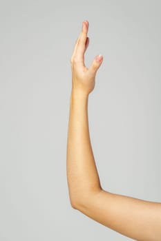 Young Woman Arm with Gesture close up on gray background