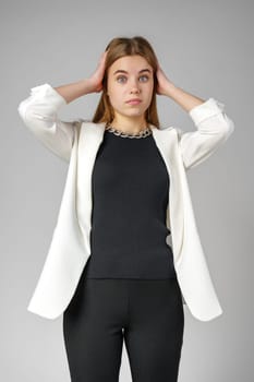 Excited Young Woman in Stylish Outfit Surprised Expression in Studio