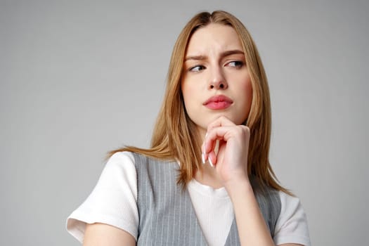 Young Woman Wearing Gray Suit and White Shirt on gray background