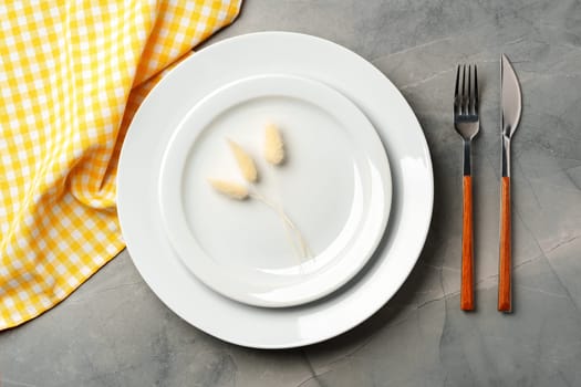 Empty plate with fork and knife on table close up