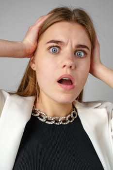 Excited Young Woman in Stylish Outfit Surprised Expression in Studio