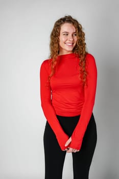 Young Woman With Curly Hair Portrait against gray background in studio