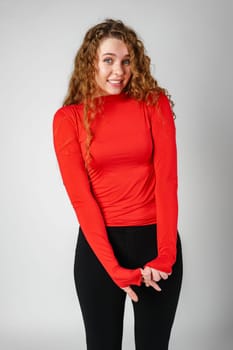 Young Woman With Curly Hair Portrait against gray background in studio
