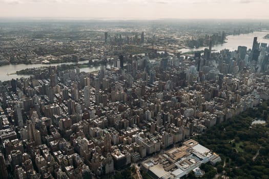 Stunning aerial view of New York City featuring the dense urban landscape, iconic skyline, and lush Central Park. Captured on a sunny day, showcasing the vibrant and bustling nature of the city.