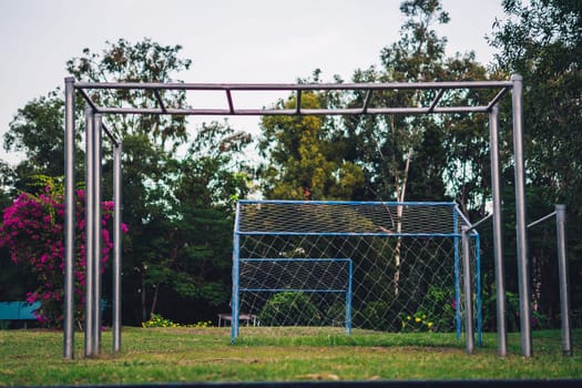 Pull-up bar ladder fitness equipment football goal in park, beautiful nature background, summer mood.