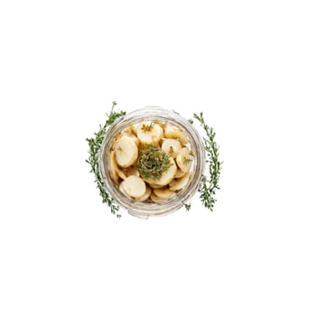 Pickled sunchokes crisp and earthy fanning out of a jar with thyme sprigs and garlic. Food isolated on transparent background.