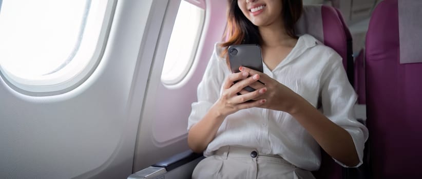 Businesswoman working and traveling on airplane seat. Concept of travel and communication.