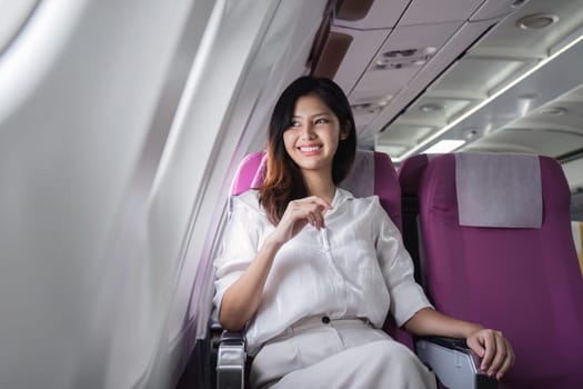 Businesswoman traveling on airplane seat. Concept of business travel and work.