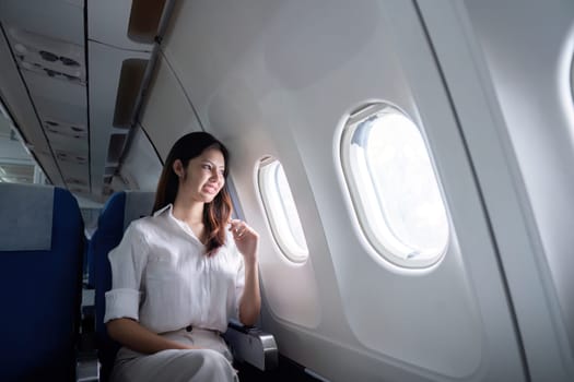 Businesswoman traveling on an airplane. Concept of business travel and work.
