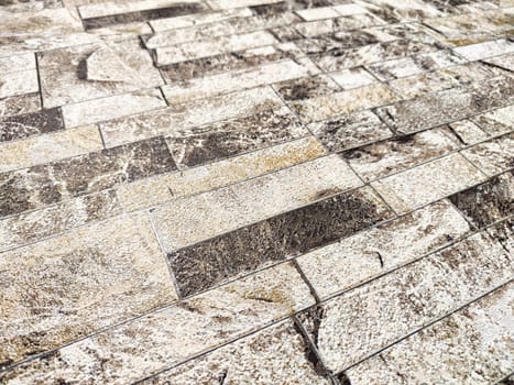 Multicolored stone bricks arranged in a staggered pattern. Background, texture, pattern, copy space