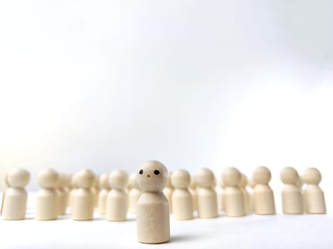 Wooden figurines with a leader and a group. Different, independent, sighted, determined, at head of group. Leadership concept, manager, influencer, CEO, market, opinion leader and business leader