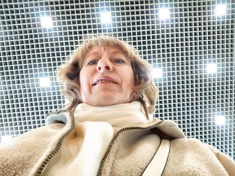 Middle-Aged Woman Captures Selfie While Shopping Indoors. Smiling adult shopper takes self-portrait during an indoor shopping trip