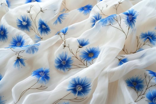 Horizontal background with the texture of linen fabric and cornflowers embroidered on it. Textiles for a cozy home.