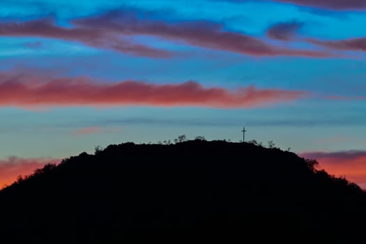 Silhouetted Christian cross on a hill near Uvalde Texas.