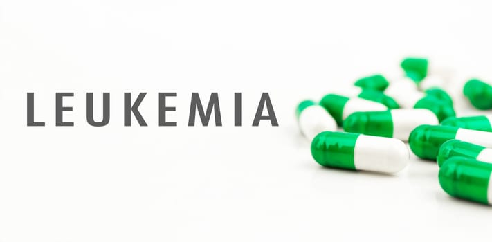 A bunch of pills with the word Leukemia written on them. The pills are green and white