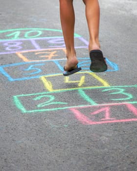 Children play hopscotch on the street. Selective focus. Nature.