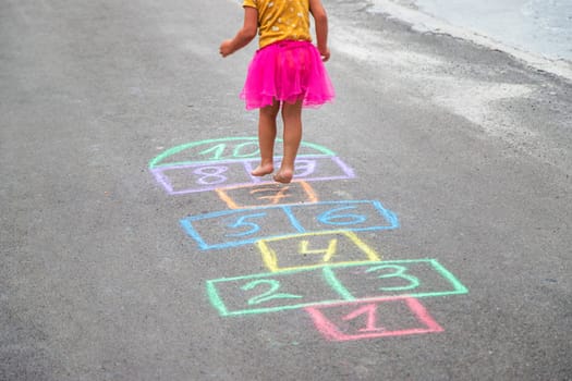 Children play hopscotch on the street. Selective focus. Nature.