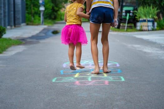 Children play hopscotch on the street. Selective focus. Nature.